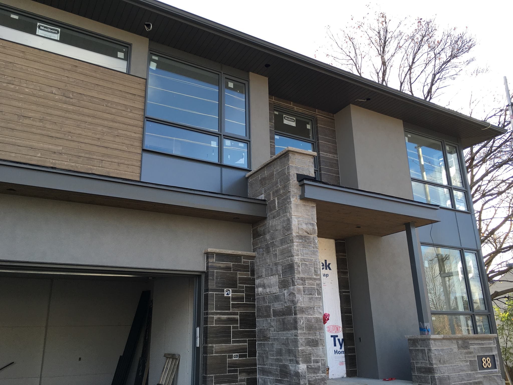 Home exterior finishing in Quebec featuring an Exterior Insulation and Finish System (EIFS) façade, a multilayer setup providing insulation, moisture resistance, and an attractive finish that enhances the building’s energy efficiency.
