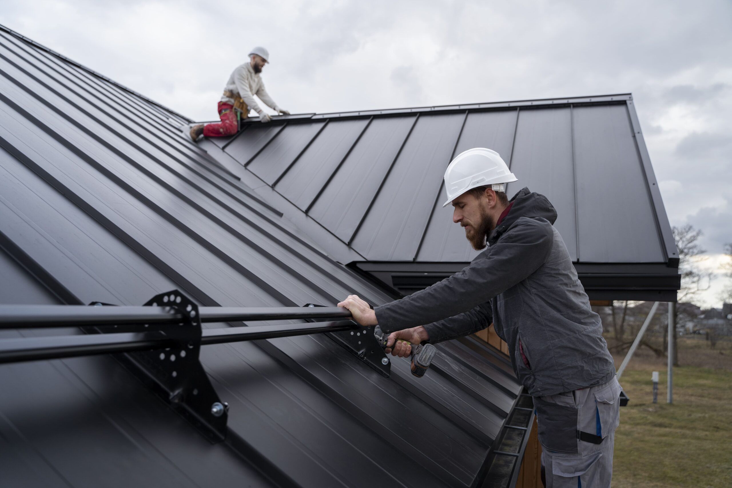 Roof repair in Quebec showing the installation of a standing seam metal roof with interlocking panels and concealed fasteners, known for its durability, weather resistance, and energy efficiency.