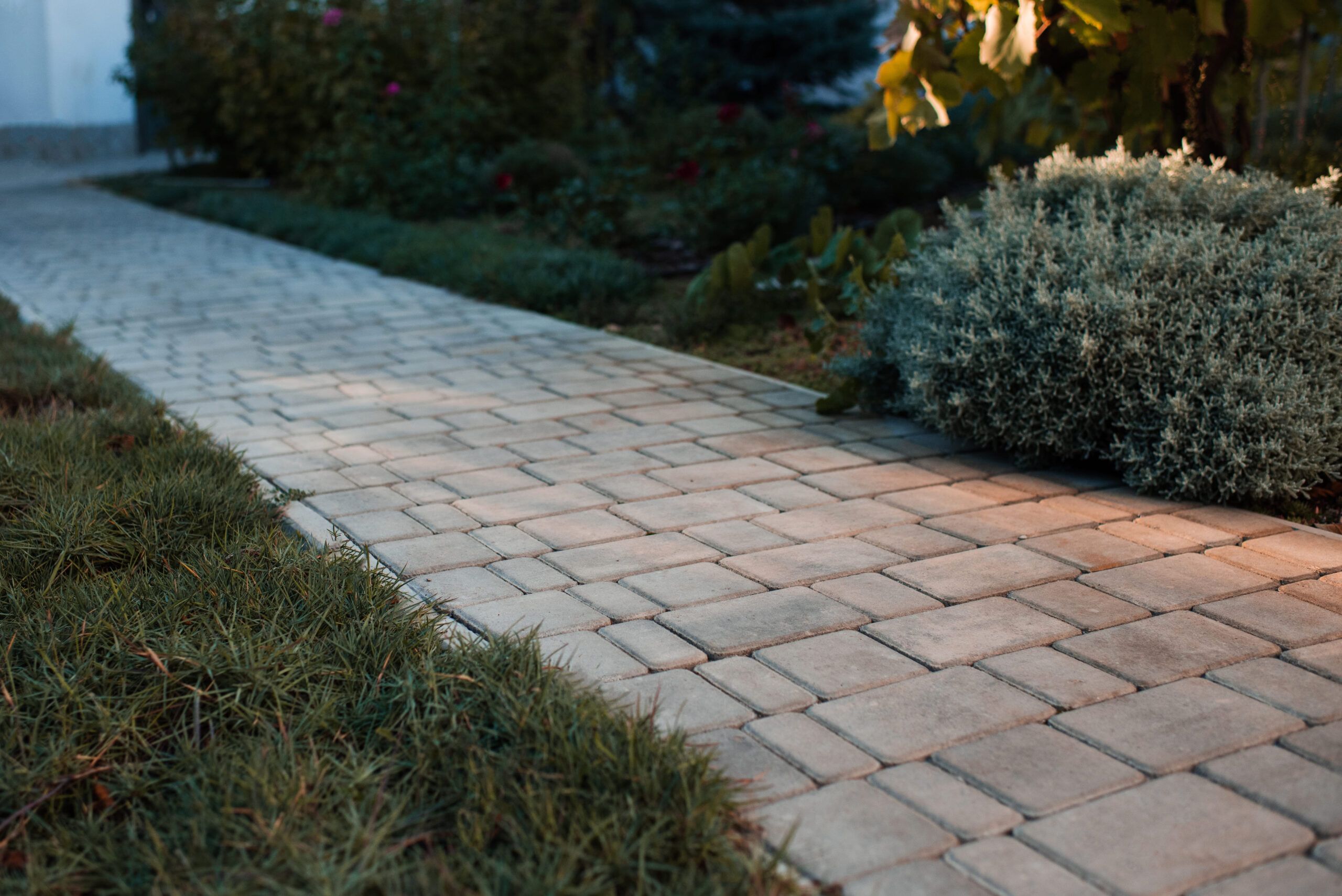 Stone-paved walkway made of interlocking pavers, illustrating professional landscaping and outdoor surface design services in Montreal