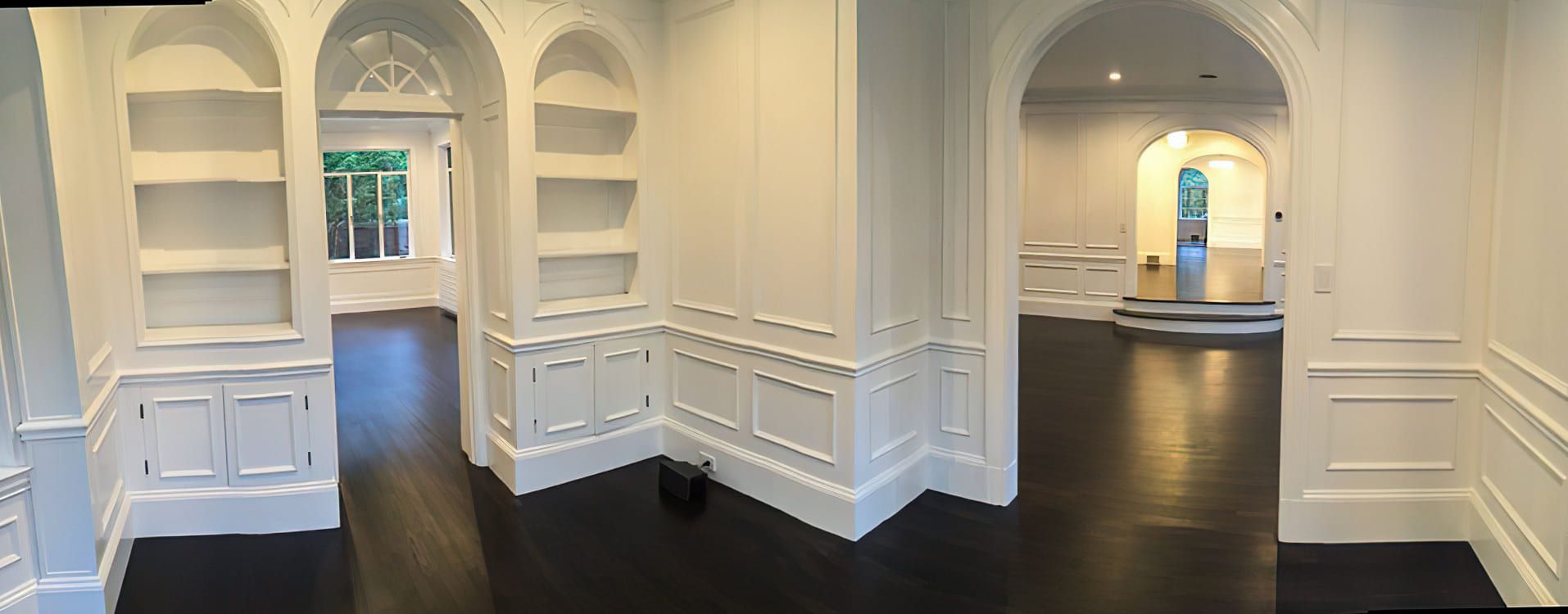 A room decorated with detailed wall moldings and stucco work. Ornamental stucco adds texture and elegance to interior walls and ceilings, blending classic craftsmanship with modern design.