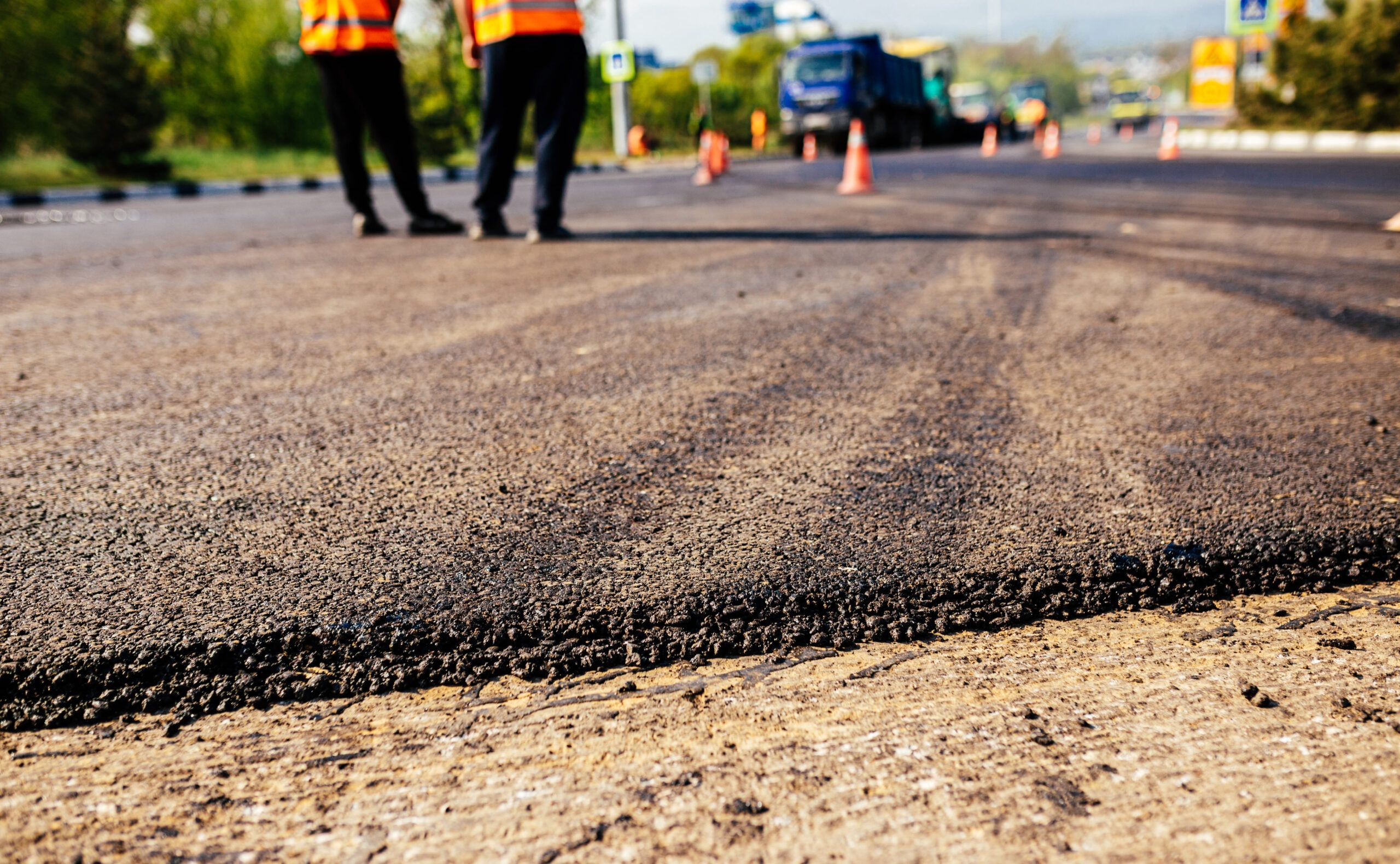 Paving Services in Montreal showing a freshly asphalted road with smooth black surface layers, demonstrating professional road construction and quality pavement work.
