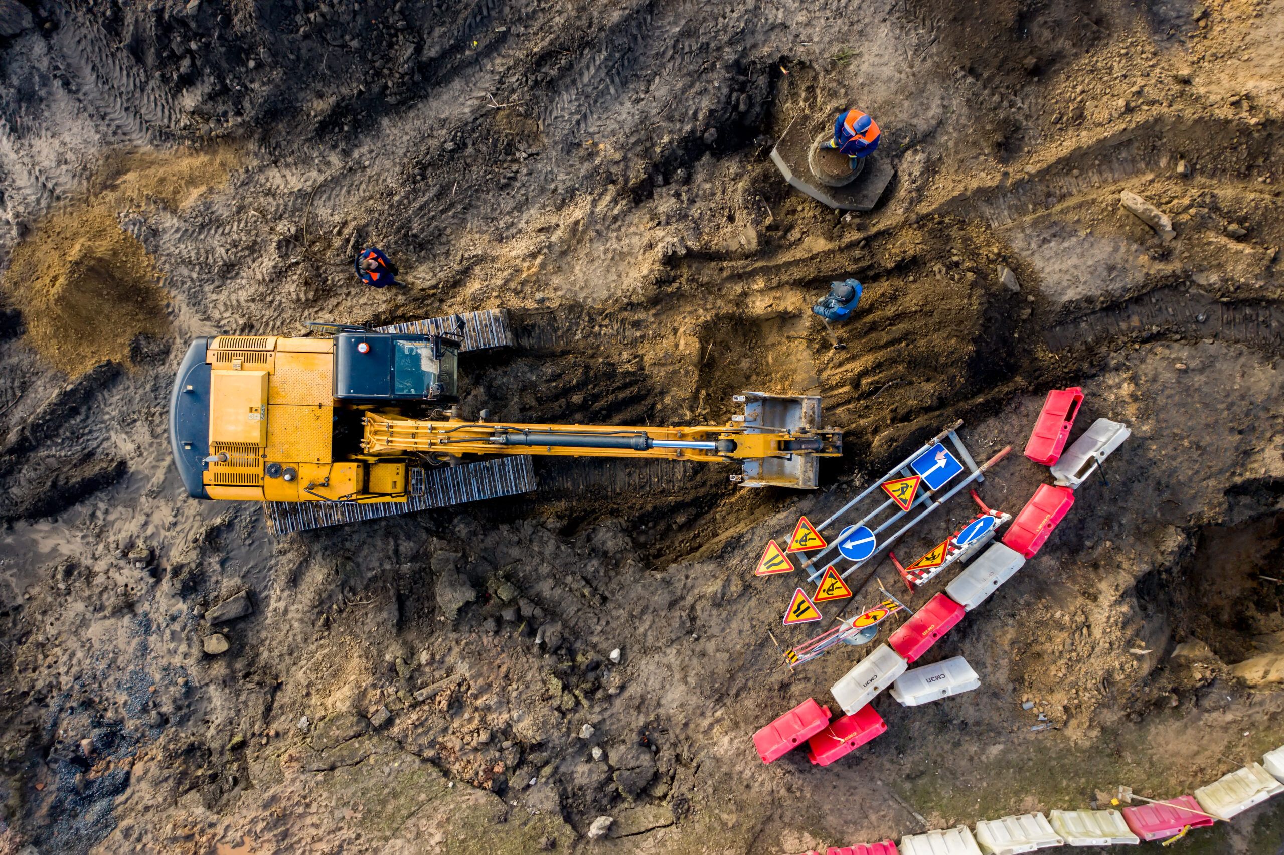 Excavation services in Quebec and Montreal shown from an aerial view, featuring an excavator working on a construction site, used for digging, earthmoving, and foundation preparation.