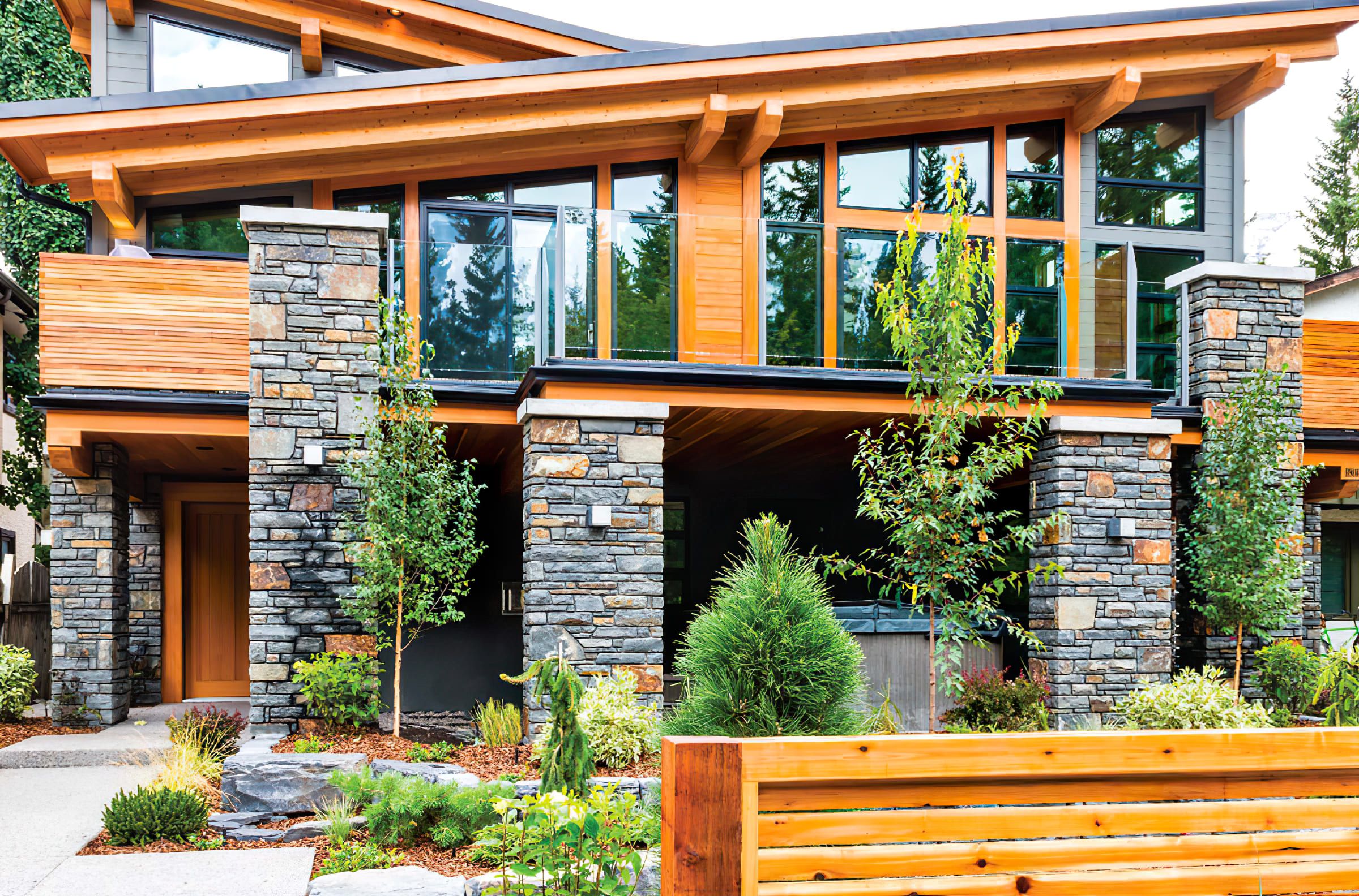 A house built in the Mountain Modern architectural style, showcasing home exterior finishing services in Quebec that blend natural materials like wood and stone with large windows and clean, modern lines for a warm, nature-inspired design.