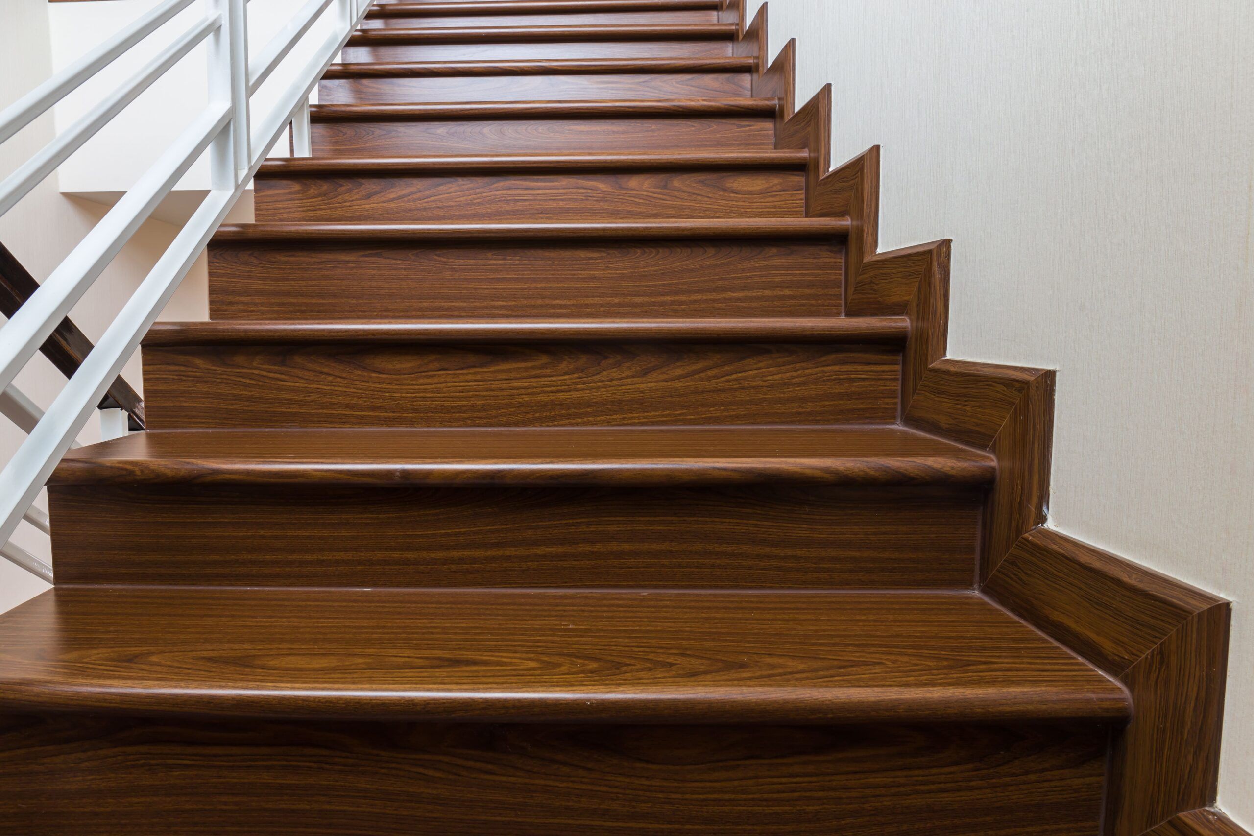 Interior stairs installation in Quebec showing a wooden staircase with a landing, featuring a U-shaped design that enhances safety and functionality while adding warmth and elegance to the interior.