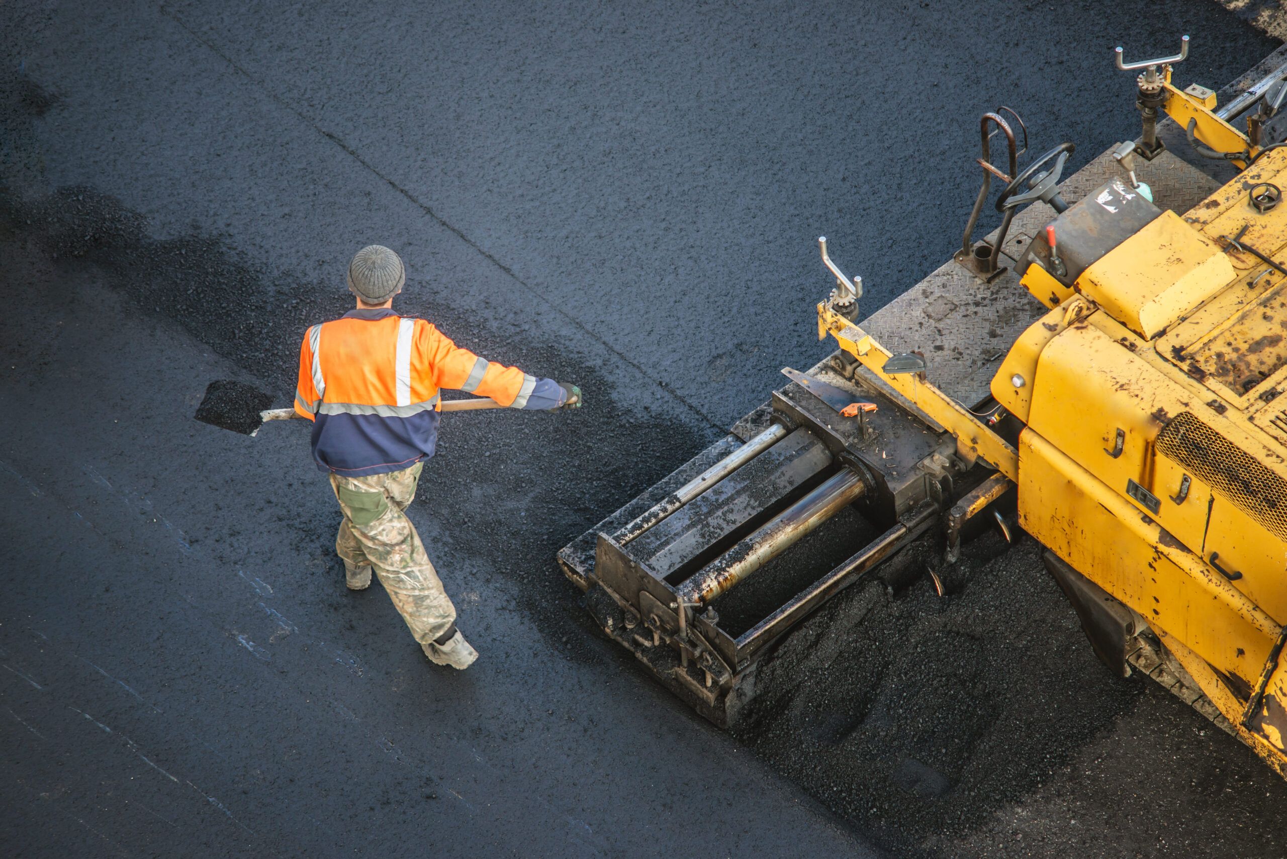 Asphalt Repair in Quebec showing a road construction site where fresh asphalt is being applied to restore and strengthen the roadway surface.