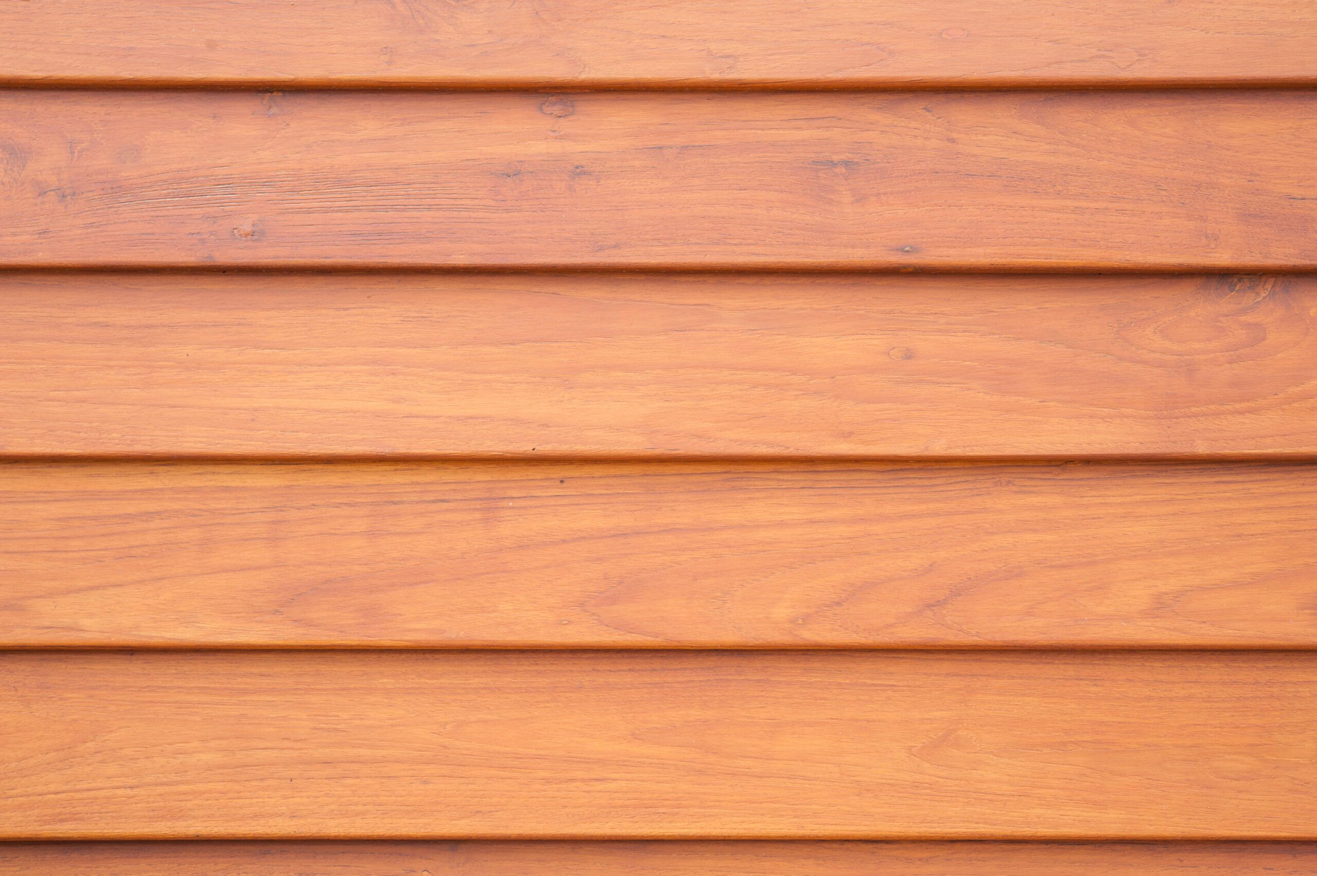 Horizontal wooden cladding boards overlapping slightly in a style known as shiplap — a common feature of exterior finishings services in Quebec and Montreal, used to enhance both protection and aesthetics of building façades.