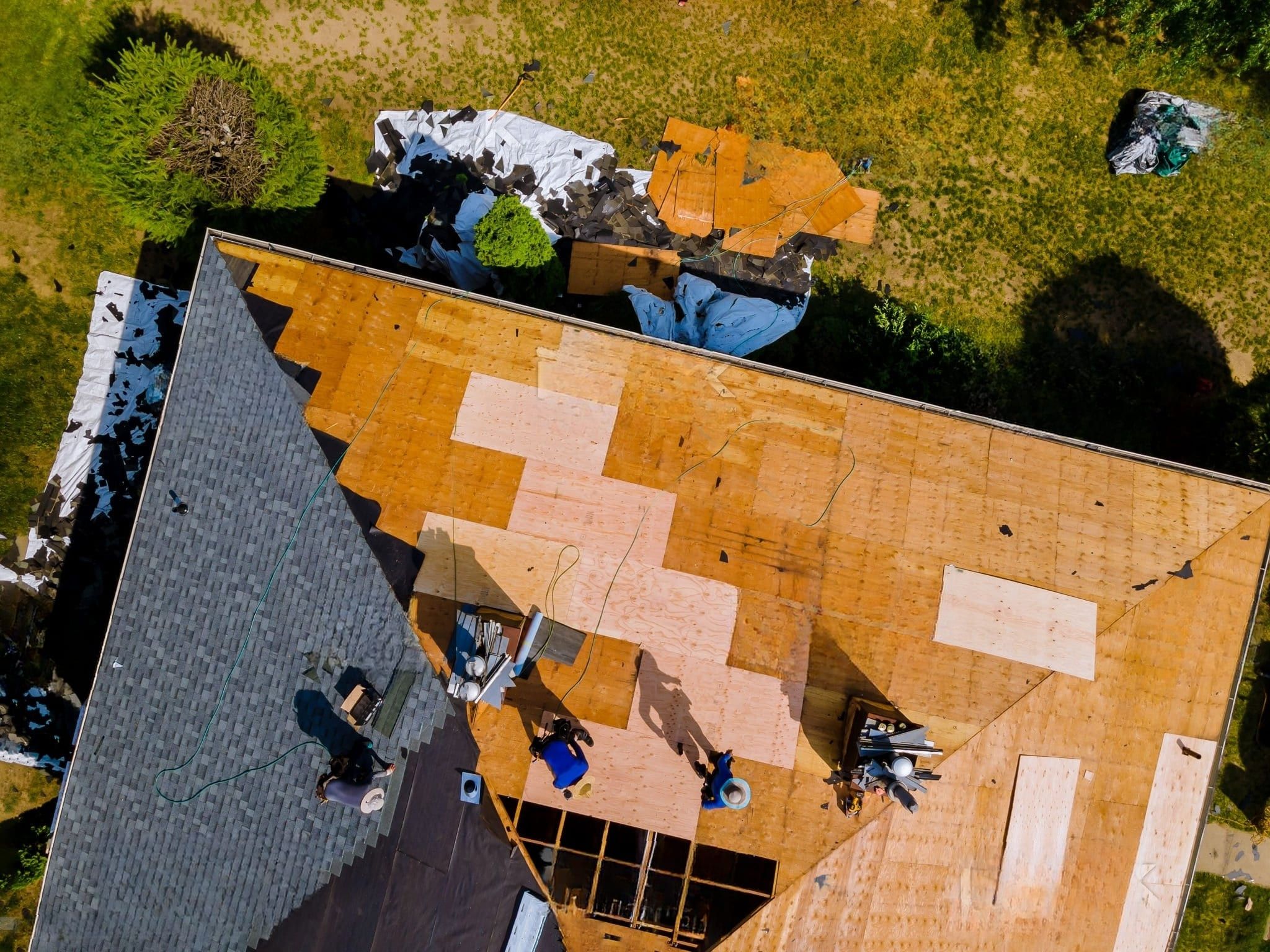A roof installation project in Quebec showing the renovation of a house with a hip or pyramid roof. The sloped roof surfaces meet at a central ridge point, typical of a pyramid-shaped roof design that offers high wind resistance and structural stability.