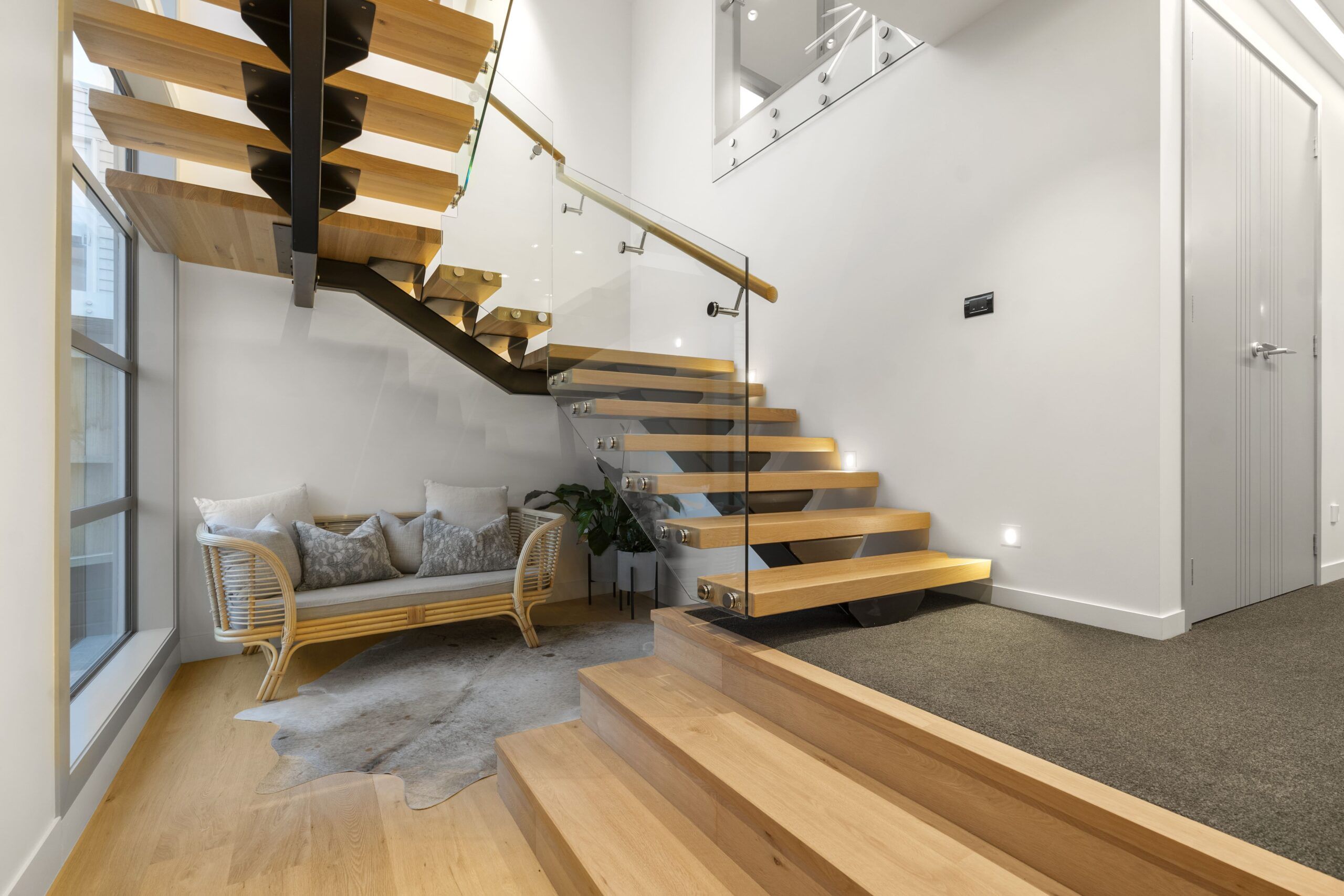 A prefabricated freestanding staircase installation in Quebec, featuring a modern design made from wood and steel, highlighting the efficiency and consistent quality of factory-built stair systems.