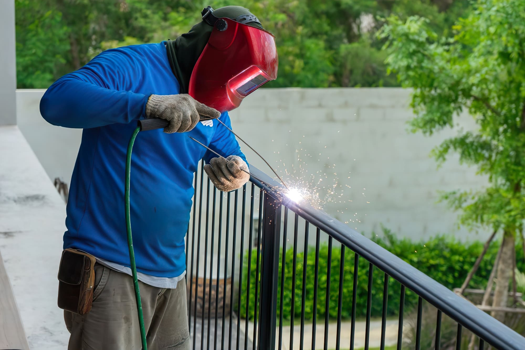welder working in Quebec wearing protective gear and helmet — the image shows a person performing welding, joining metal parts using intense heat and sparks; welding is a key process in construction, manufacturing, and shipbuilding, creating strong, permanent metal bonds.